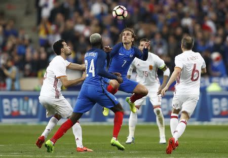 Football Soccer - France v Spain - International Friendly - Stade de France, Saint-Denis near Paris, France - 28/3/17 France's Antoine Griezmann and Tiemoue Bakayoko in action with Spain's Sergio Busquets Reuters / Gonzalo Fuentes Livepic