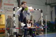 A girl competes during a Hobby horsing competition in St. Petersburg, Russia, on Sunday, April 21, 2024. Several dozen kids, 48 girls and one boy, from first-graders to teenagers gathered in a gymnasium in northern St. Petersburg, Russia's second largest city, for a hobby horsing competition. (AP Photo/Dmitri Lovetsky)