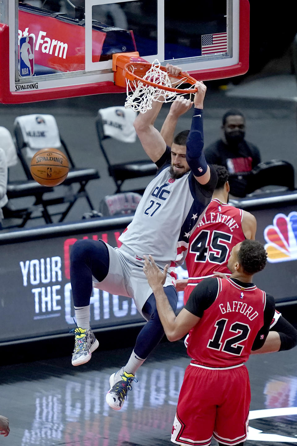 Washington Wizards' Alex Len dunks the ball past Chicago Bulls' Denzel Valentine (45) as Daniel Gafford watches during the first half of an NBA basketball game Monday, Feb. 8, 2021, in Chicago. (AP Photo/Charles Rex Arbogast)
