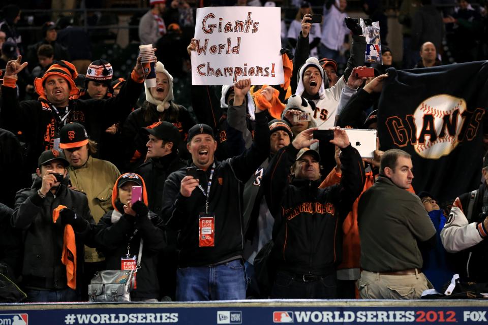 The San Francisco Giants fans hold up a sign that reads, "Giants World Champions!" after defeating the Detroit Tigers in the tenth inning to win Game Four of the Major League Baseball World Series at Comerica Park on October 28, 2012 in Detroit, Michigan. The San Francisco Giants defeated the Detroit Tigers 4-3 in the tenth inning to win the World Series in 4 straight games. (Photo by Doug Pensinger/Getty Images)