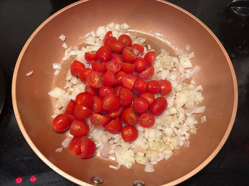 Adding tomatoes to pan for Gordon Ramsay's 10-minute scampi
