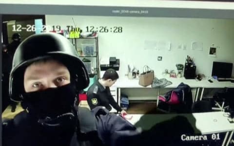 A still image shows the moment police officers disabled security cameras in the office of Alexei Navalny's anti corruption foundation - Credit: Anti-Corruption Foundation/VIA REUTERS