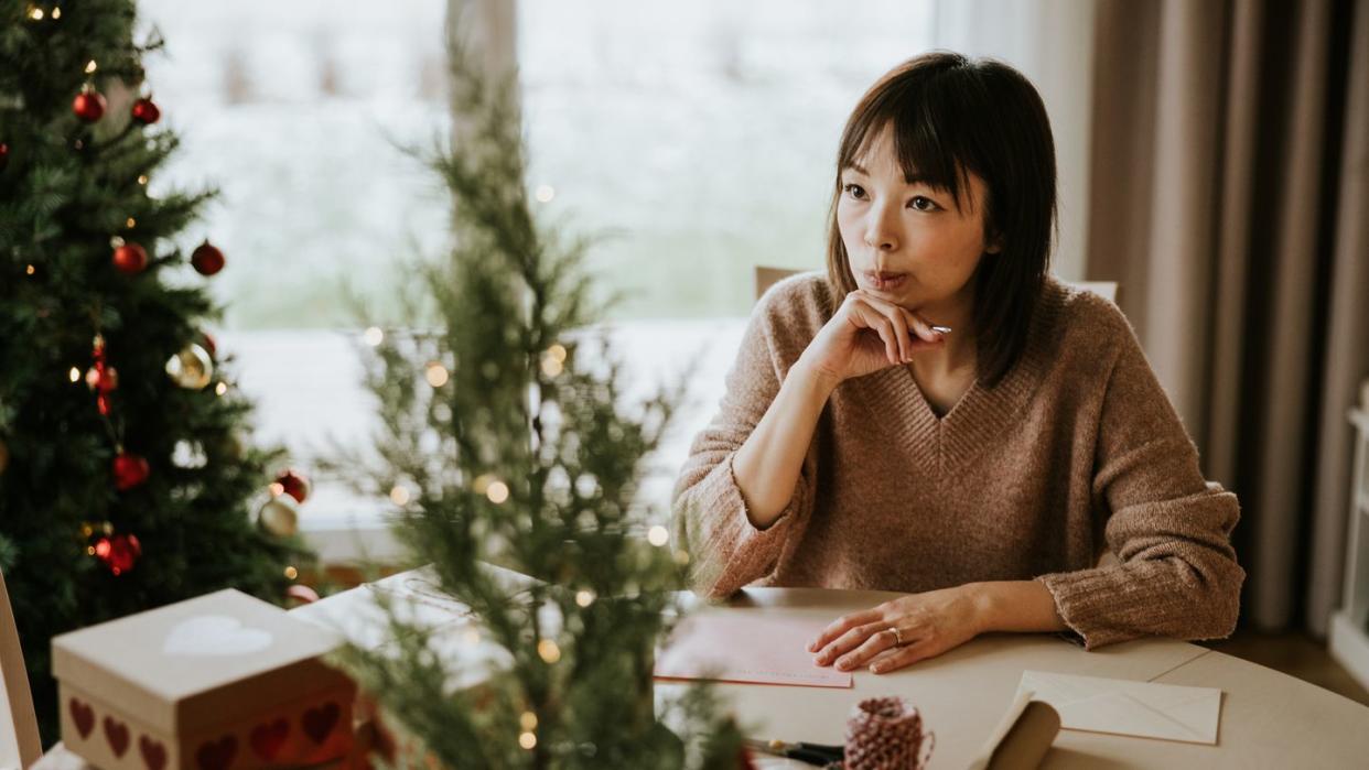 woman writing a christmas card