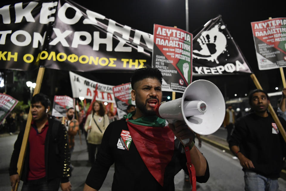 Pro Palestinian protesters take part in a rally in Athens, Friday, Nov. 17, 2023. Thousands of people are marching through central Athens to mark the 50th anniversary of a pro-democracy student uprising that was violently put down by the military dictatorship ruling Greece in 1973. (AP Photo/Michael Varaklas)