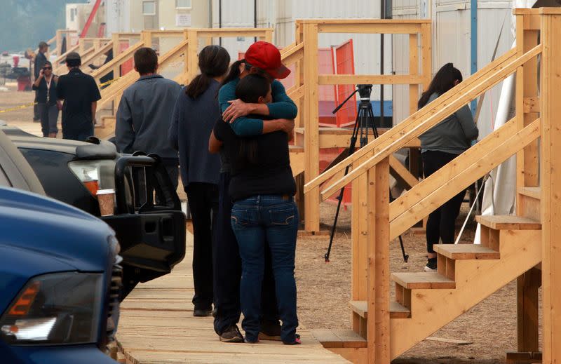 People share a moment at the Tselletkwe Lodge, a safe place for Indigenous evacuees and others who've been displaced due to the wildfires in Kamloops