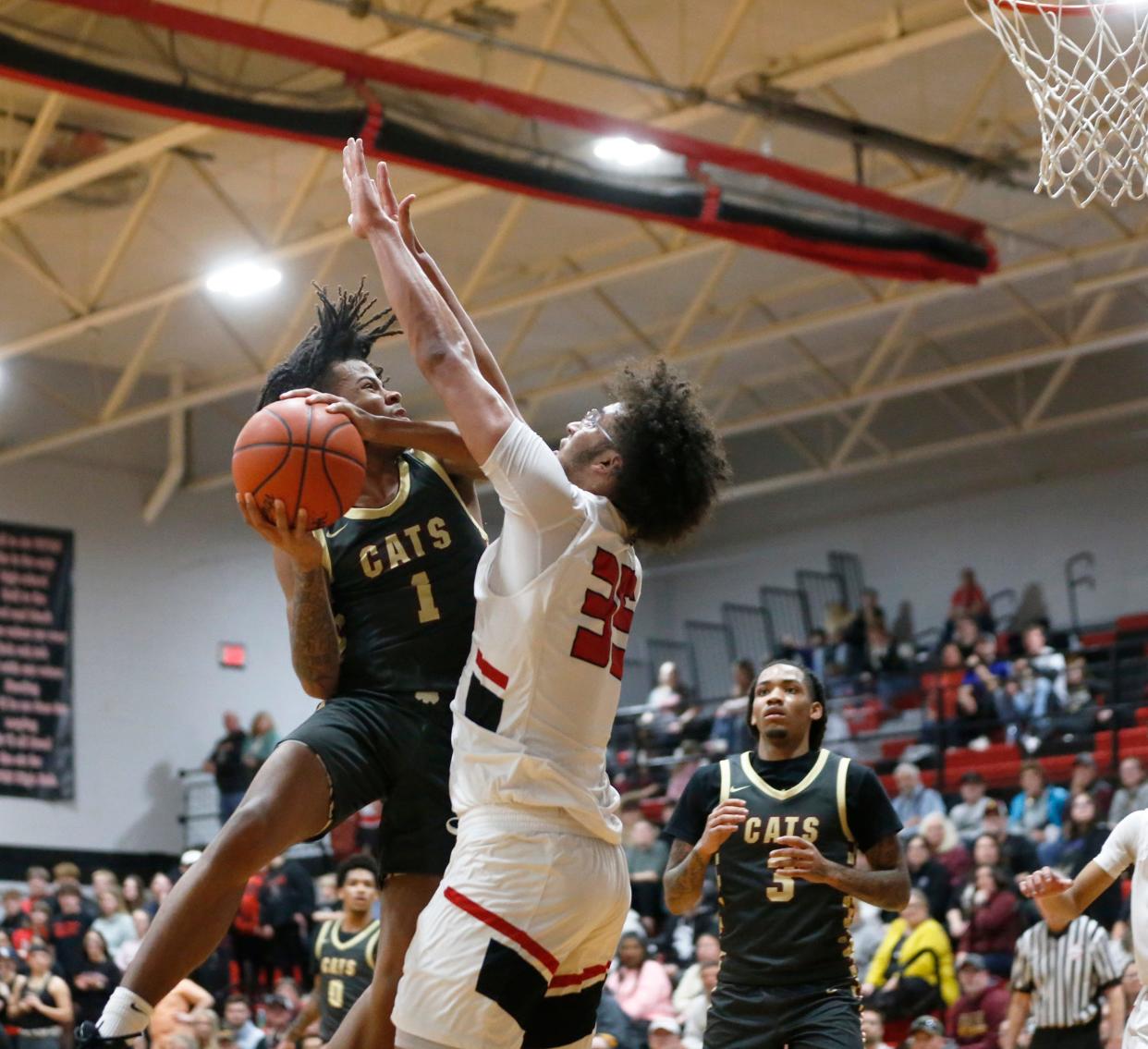 Brandywine sophomore Nylen Goins (1) puts up a shot over White Pigeon junior Wes Roberts during the MHSAA Division 3, District 79 championship game Friday, March 1, 2024, at White Pigeon High School.