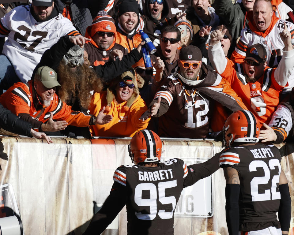 Cleveland Browns defensive end Myles Garrett (95) celebrates with fans after scoring a touchdown during the first half of an NFL football game against the Baltimore Ravens, Sunday, Dec. 12, 2021, in Cleveland. (AP Photo/Ron Schwane)