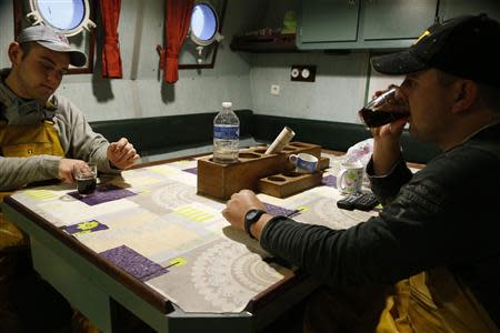 Fishermen Vincent Margolle (L) and his brother Jeremy (R) drink coffee aboard the Boulogne sur Mer based trawler "Nicolas Jeremy" off the coast of northern France October 21, 2013. REUTERS/Pascal Rossignol