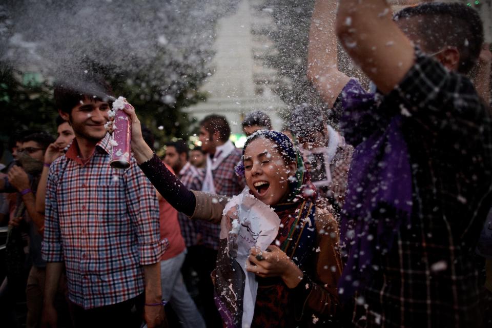 Iranians celebrate along Valiasr street,  in the capital Tehran, on June 15, 2013, after moderate presidential candidate Hassan Rouhani was elected as president. (BEHROUZ MEHRI/AFP/Getty Images)