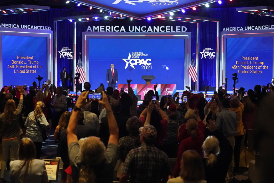 Supporters cheer and wave as former president Donald Trump is introduced at the Conservative Political Action Conference (CPAC) Sunday, Feb. 28, 2021, in Orlando, Fla. (AP Photo/John Raoux)