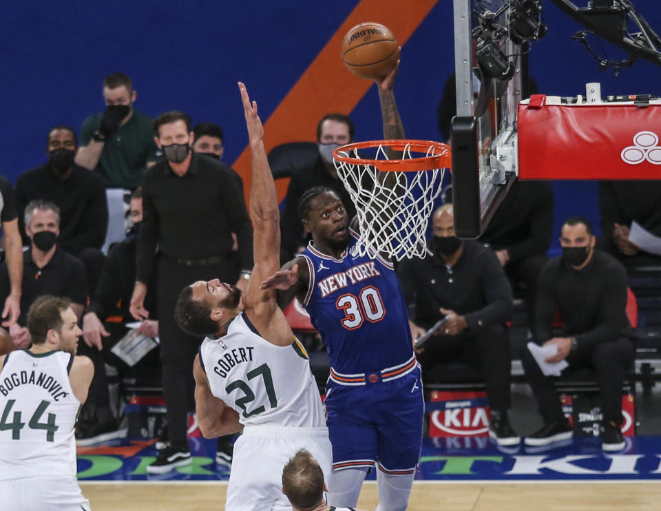 New York Knicks forward Julius Randle (30) dunks next to Utah Jazz center Rudy Gobert (27) during the first half of an NBA basketball game Wednesday, Jan. 6, 2021, in New York. (Wendell Cruz/Pool Photo via AP)