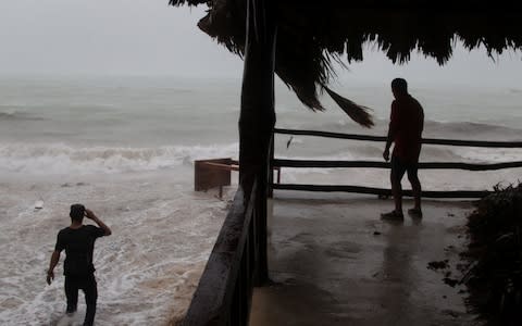 A man tries to salvage a table belonging to his restaurant before the arrival of Hurricane Maria in Punta Cana - Credit: Reuters