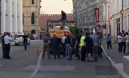 A damaged taxi, which ran into a crowd of people, is evacuated in central Moscow, Russia June 16, 2018. REUTERS/Jack Stubbs