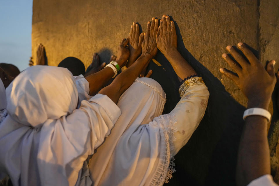 Muslim pilgrims prayers at top of the rocky hill known as the Mountain of Mercy, on the Plain of Arafat, during the annual Hajj pilgrimage, near the holy city of Mecca, Saudi Arabia, Saturday, June 15, 2024. Masses of Muslims gathered at the sacred hill of Mount Arafat in Saudi Arabia for worship and reflection on the second day of the Hajj pilgrimage. The ritual at Mount Arafat, known as the hill of mercy, is considered the peak of the Hajj. It's often the most memorable event for pilgrims, who stand shoulder to shoulder, asking God for mercy, blessings, prosperity and good health. Hajj is one of the largest religious gatherings on earth.(AP Photo/Rafiq Maqbool)