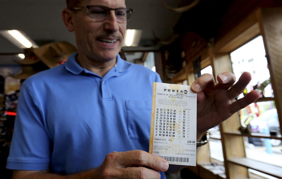 <p>Mike Coscia shows off his Powerball lottery ticket numbers he purchased at a convenience store in Dallas, Aug. 23, 2017. Lottery officials said the grand prize for Wednesday night’s drawing has reached $700 million. The second -largest on record for any U.S. lottery game. (Photo: LM Otero/AP) </p>