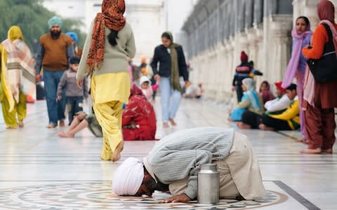 A pilgrim at The Golden Temple - Credit: AP