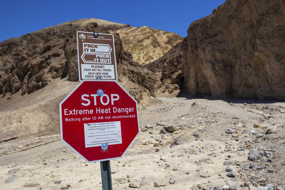 A sign stands warning hikers of extreme heat at the start of the Golden Canyon trail on July 11, 2023, in Death Valley National Park, Calif. A 71-year-old Los Angeles-area man died at the trailhead on Tuesday, July 18, as temperatures reached 121 degrees (49 Celsius) or higher and rangers suspect heat was a factor, the National Park Service said in a statement Wednesday. (AP Photo/Ty ONeil)