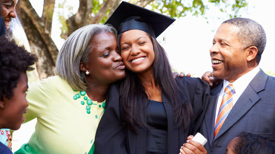 Student Celebrates Graduation With Parents.