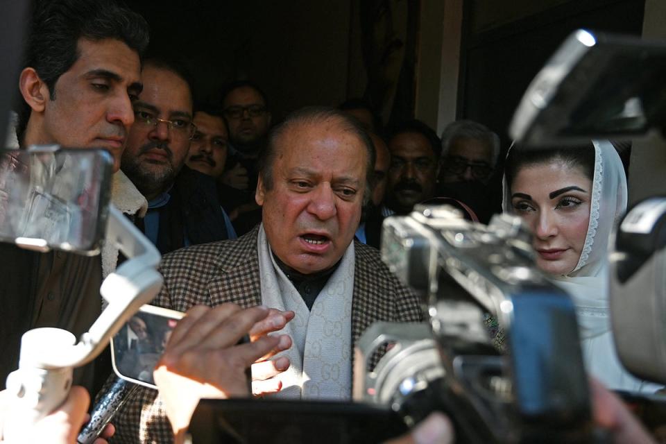 Pakistan's former Prime Minister and leader of the Pakistan Muslim League-Nawaz (PML-N) Nawaz Sharif (C) along with his daughter Maryam Nawaz (R) speaks to media after casting his ballot to vote (AFP via Getty Images)
