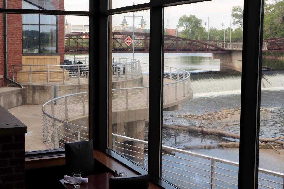 A view inside the Iowa River Power Restaurant overlooking a nearby bike path Friday, Aug. 4. The restaurant will close in November as the owner of the building, Randy Ward, begins renovations and a search for a new tenant.