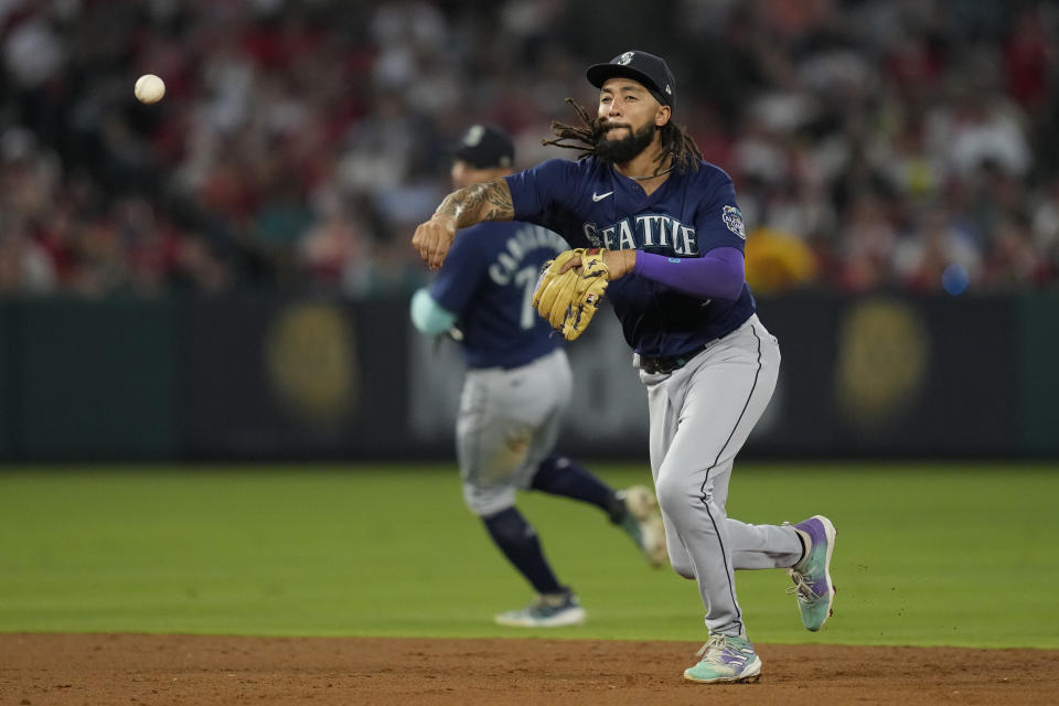 Seattle Mariners shortstop J.P. Crawford (3) throws to first to out Los Angeles Angels' C.J. Cron during the fourth inning of a baseball game in Anaheim, Calif., Friday, Aug. 4, 2023. (AP Photo/Ashley Landis)