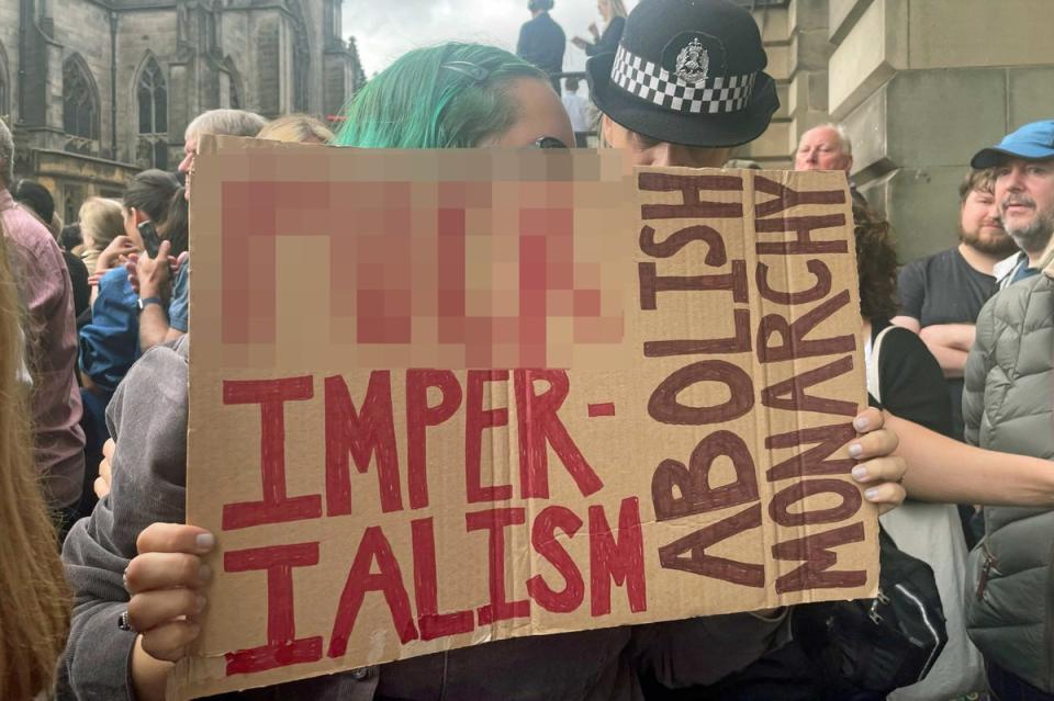 A protester before the Accession Proclamation Ceremony at  Mercat Cross, (PA)