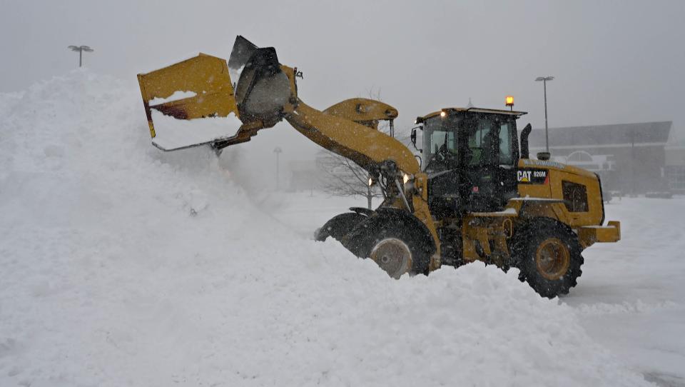 A front-end loader creates a mountain of snow in the Shaw's Plaza parking lot in Sudbury during Saturday's winter storm, Jan. 29, 2022.  