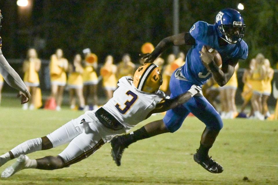 Trinity Christian running back Treyaun Webb (right) tries to break the tackle of Columbia defensive back Jerome Fulton in the teams' 2020 high school football clash.