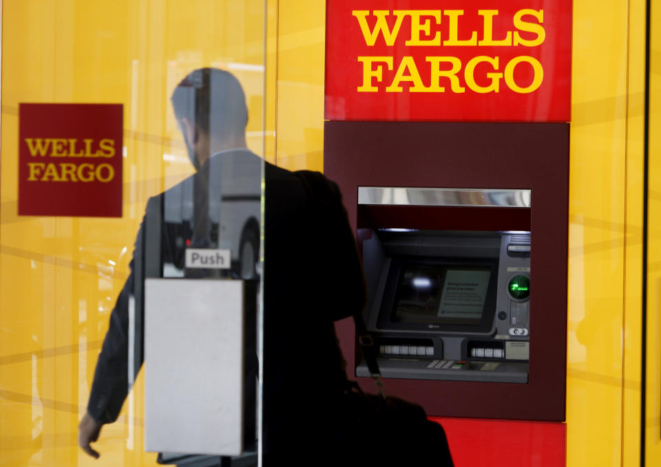 FILE PHOTO: A man walks by an ATM at the Wells Fargo & Co. bank in downtown Denver, U.S., April 13, 2016. REUTERS/Rick Wilking/File Photo