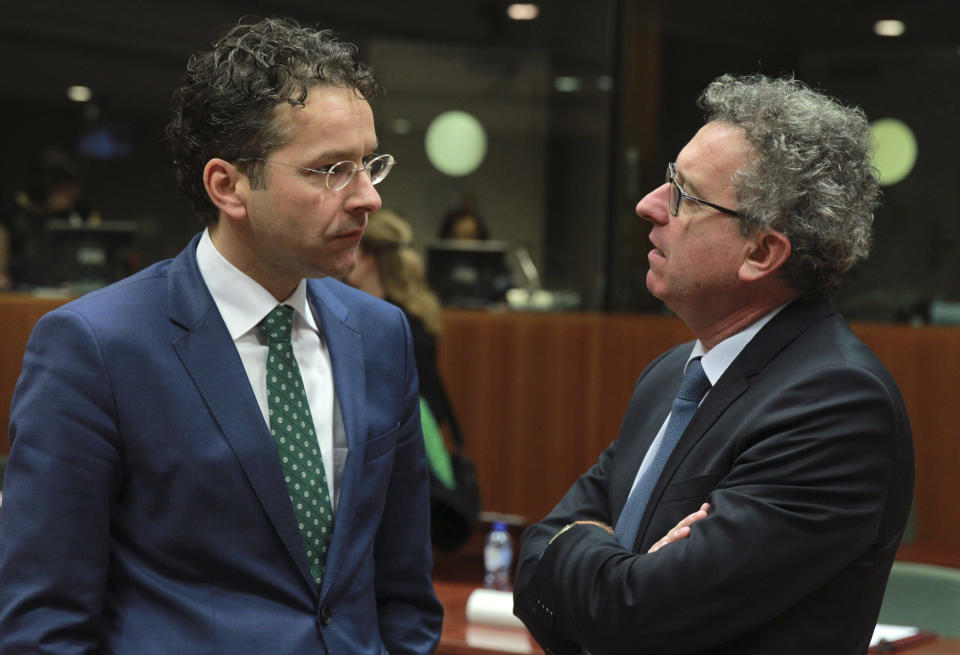 Netherlands' Finance Minister Jeroen Dijsselbloem, left, talks with his Luxembourg's counterpart Pierre Gramegna at the start of an EU finance ministers meeting at the European Council building in Brussels, Tuesday, March 11, 2014. The Council prepares the presidency's mandate to finalize negotiations with the European Parliament on the proposal for a single resolution mechanism for banks. (AP Photo/Yves Logghe)