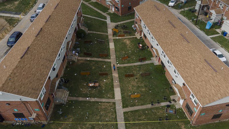 Tables are left on their side in the area of a mass shooting incident in the Southern District of Baltimore, Sunday, July 2, 2023. Police say two people were killed and 28 were wounded in a mass shooting that took place during a block party just after midnight.