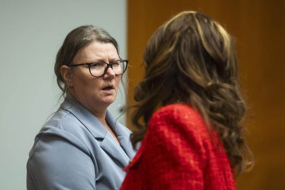 Defendant Jennifer Crumbley, left, speaks with her attorney during her jury trial at the Oakland County Courthouse on Wednesday, Jan. 31, 2024, in Pontiac, Mich. Jennifer Crumbley is charged with involuntary manslaughter for gross negligence in connection with her son Ethan Crumbley who shot and killed four classmates at Oxford High School in November 2021. James Crumbley, Ethan's father, is also charged with involuntary manslaughter but will be tried separately. (Katy Kildee/Detroit News via AP, Pool)