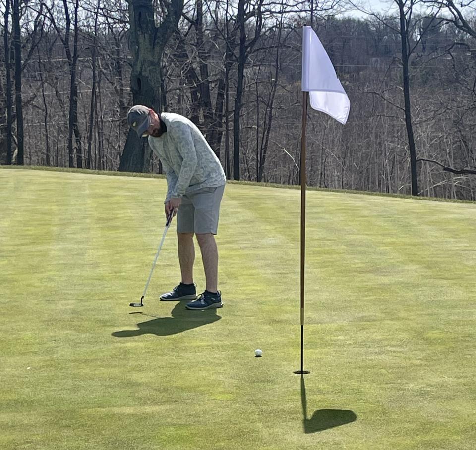 A Worcester Country Club member putts on the new 11th green.