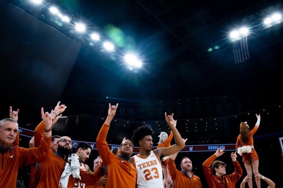 Texas forward Dillon Mitchell, right, embraces coach Rodney Terry during "The Eyes of Texas" following the Longhorns' 79-75 win over the TCU Horned Frogs at the Moody Center last season. The Big 12 released its conference schedule for the 2023-24 season, which will mark Texas' final season in the Big 12 before joining the SEC in July.