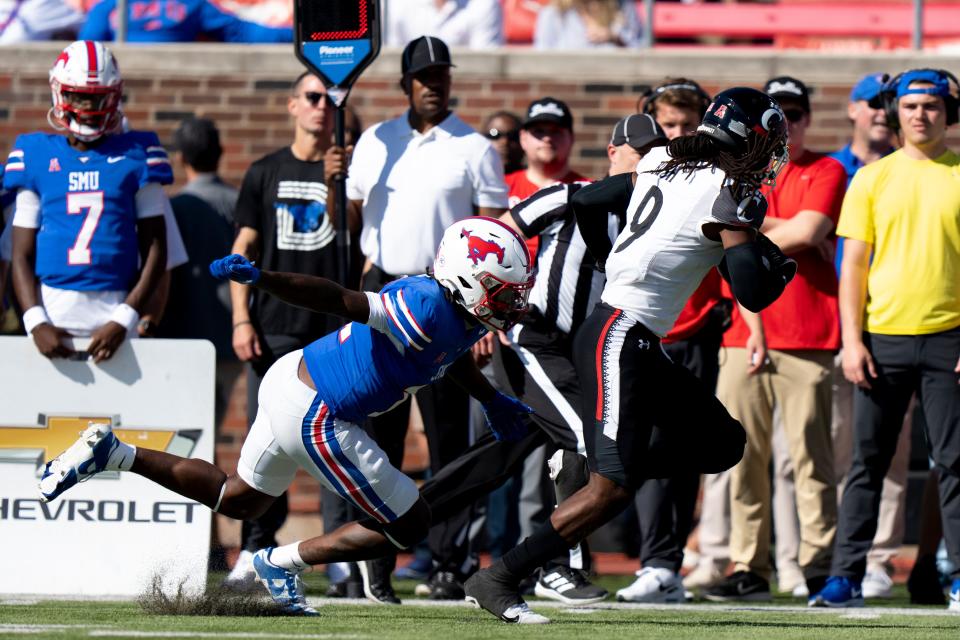 Cincinnati Bearcats cornerback Arquon Bush (9) intercepts a pass intended for Southern Methodist Mustangs defensive end Je'lin Samuels (11) in the first quarter of the American Athletic Conference game between the Cincinnati Bearcats and the Southern Methodist Mustangs at Gerald J. Ford Stadium in Dallas on Saturday, Oct. 22, 2022.