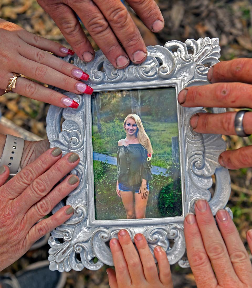 Ashley Jade Zadai's family gathers around her photo, in her memory.