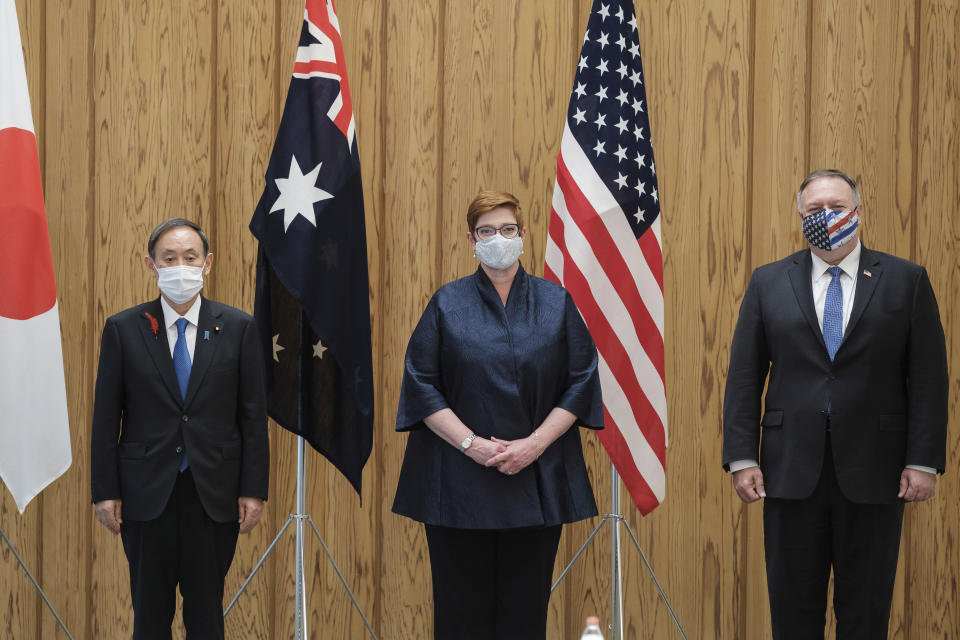 Japanese Prime Minister Yoshihide Suga, left, Australia Foreign Minister Marise Payne, center, and U.S. Secretary of State Mike Pompeo pose for a picture before a four Indo-Pacific nations' foreign ministers meeting at the prime minister's office in Tokyo Tuesday, Oct. 6, 2020. (Nicolas Datiche/Pool Photo via AP)