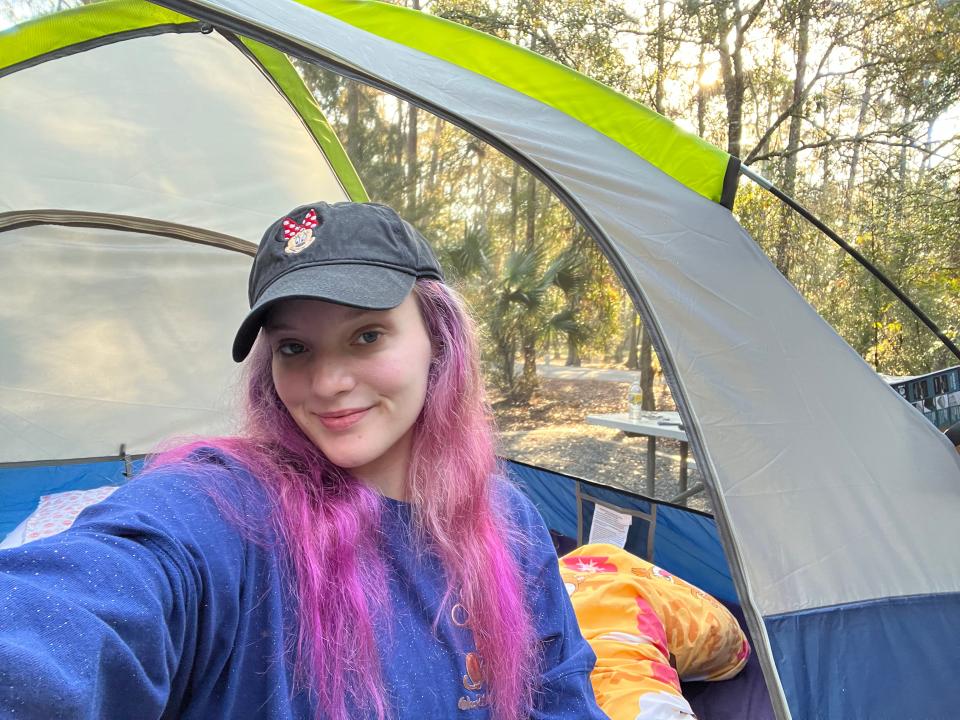 the writer taking a selfie with her tent