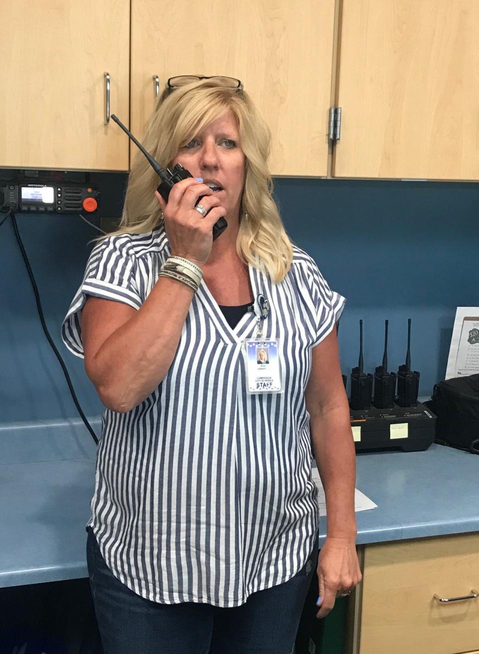 Cambridge High School Administrative Assistant Kim Valentine uses the two-way radio to communicate with principals, school resource officers and others.