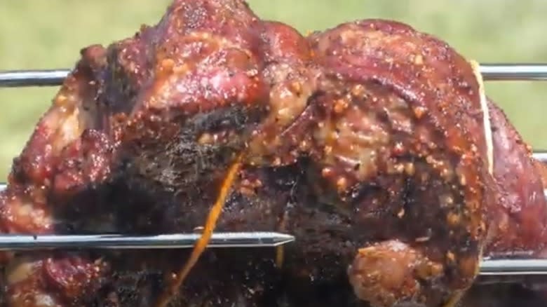 Beef chuck roast on barbecue spit