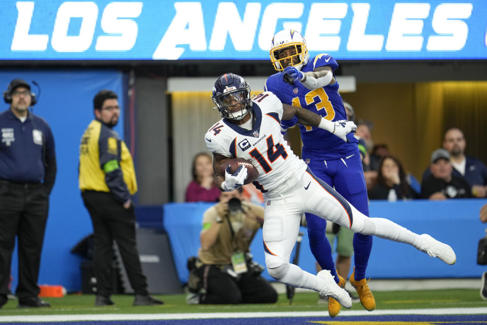 Denver Broncos wide receiver Courtland Sutton (14) catches a touchdown pass under pressure by Los Angeles Chargers cornerback Michael Davis (43) during the second half of an NFL football game Sunday, Dec. 10, 2023, in Inglewood, Calif. (AP Photo/Marcio Jose Sanchez)