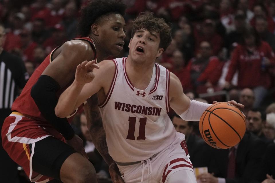 Wisconsin's Max Klesmit drives past Maryland's DeShawn Harris-Smith during the second half of an NCAA college basketball game Tuesday, Feb. 20, 2024, in Madison, Wis. (AP Photo/Morry Gash)