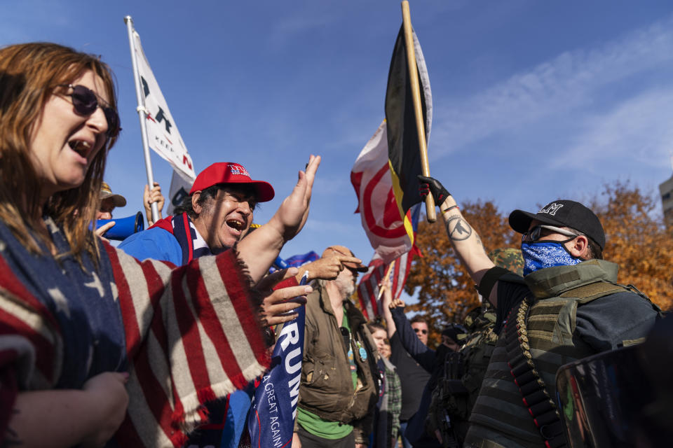 Trump supporters, at left, demonstrating the election results are confronted by counter protesters at the State Capitol in Lansing, Mich., Saturday, Nov. 7, 2020. Democrat Joe Biden defeated President Donald Trump to become the 46th president of the United States on Saturday, positioning himself to lead a nation gripped by the historic pandemic and a confluence of economic and social turmoil.(AP Photo/David Goldman)