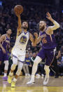 Golden State Warriors' Stephen Curry, left, lays up a shot past Phoenix Suns' Aron Baynes (46) during the first half of an NBA basketball game Wednesday, Oct. 30, 2019, in San Francisco. (AP Photo/Ben Margot)