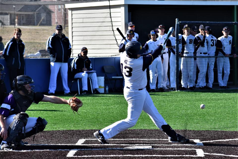 Battle's Seth Wray (13) fouls off a pitch during the Spartans' loss to Park Hill South on March 25 at Battle High School.