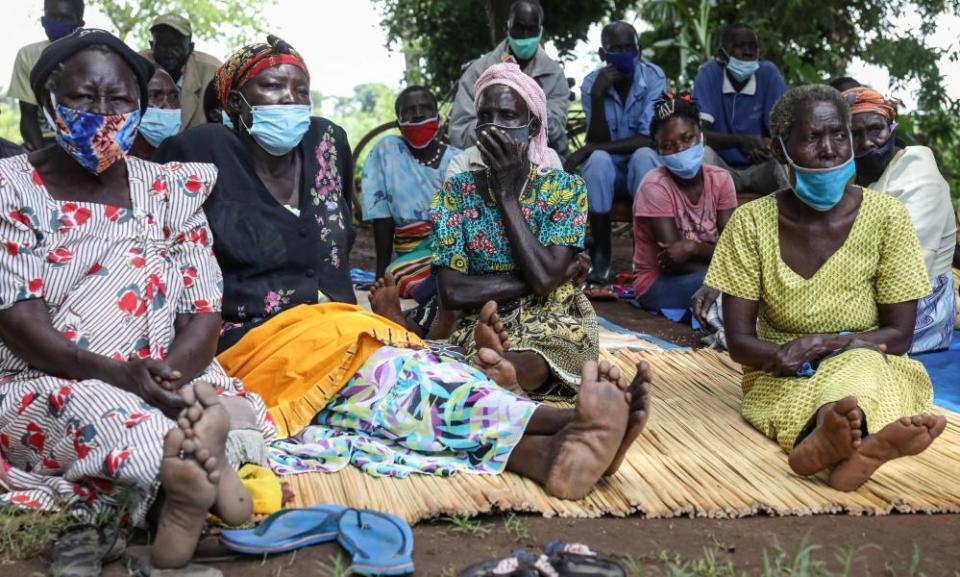 Residents of Lukodi village in Uganda listen to the sentencing of Dominic Ongwen.