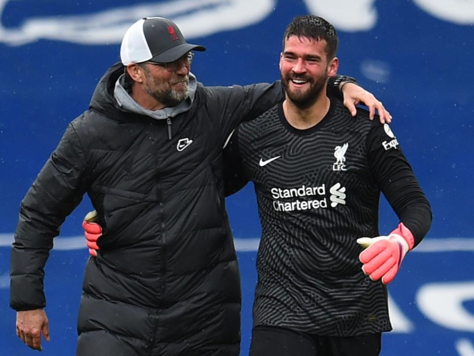 <p>Jurgen Klopp celebrates with Alisson </p> (Liverpool FC via Getty Images)