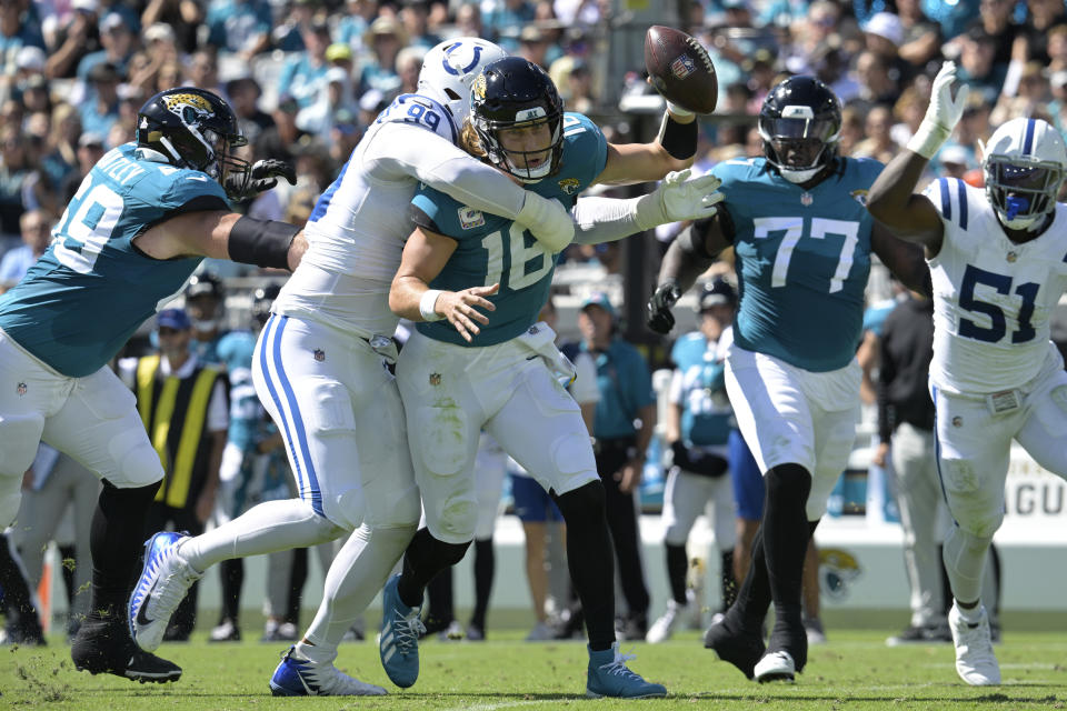 Jacksonville Jaguars quarterback Trevor Lawrence (16) is sacked by Indianapolis Colts defensive tackle DeForest Buckner (99) during the first half of an NFL football game, Sunday, Oct. 15, 2023, in Jacksonville, Fla. (AP Photo/Phelan M. Ebenhack)