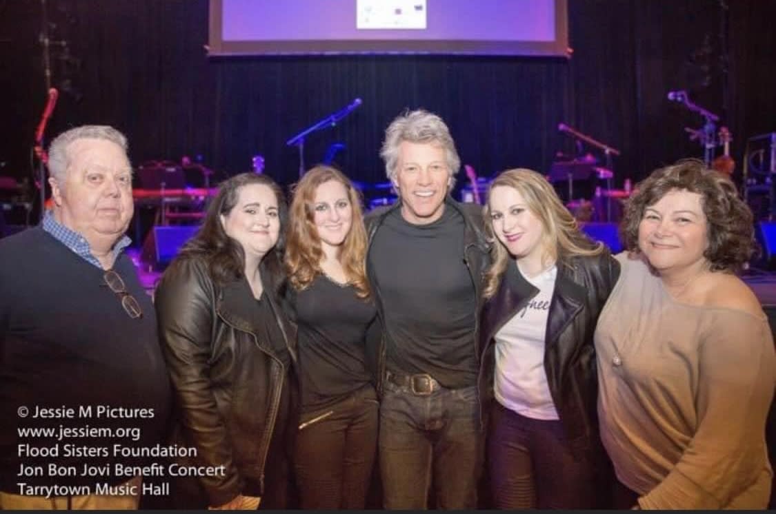 The Flood family, including Daniel's wife, Roseann, right, with singer Jon Bon Jovi.