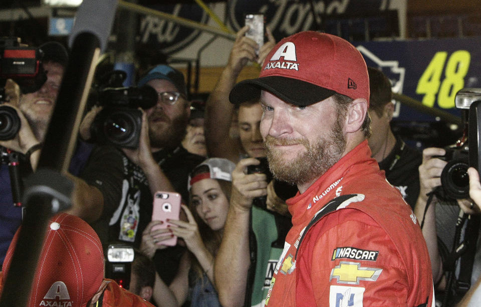 FILE - In this Nov. 19, 2017, file photo, Dale Earnhardt Jr. is surrounded upon getting out of his car after a NASCAR Cup Series auto race at Homestead-Miami Speedway in Homestead, Fla. Dale Earnhardt Jr. is returning to the track Saturday, June 13, 2020, getting behind the wheel for an Xfinity race at Homestead-Miami Speedway -- the place where his Cup Series career ended three years ago. (AP Photo/Darryl Graham, FIle)